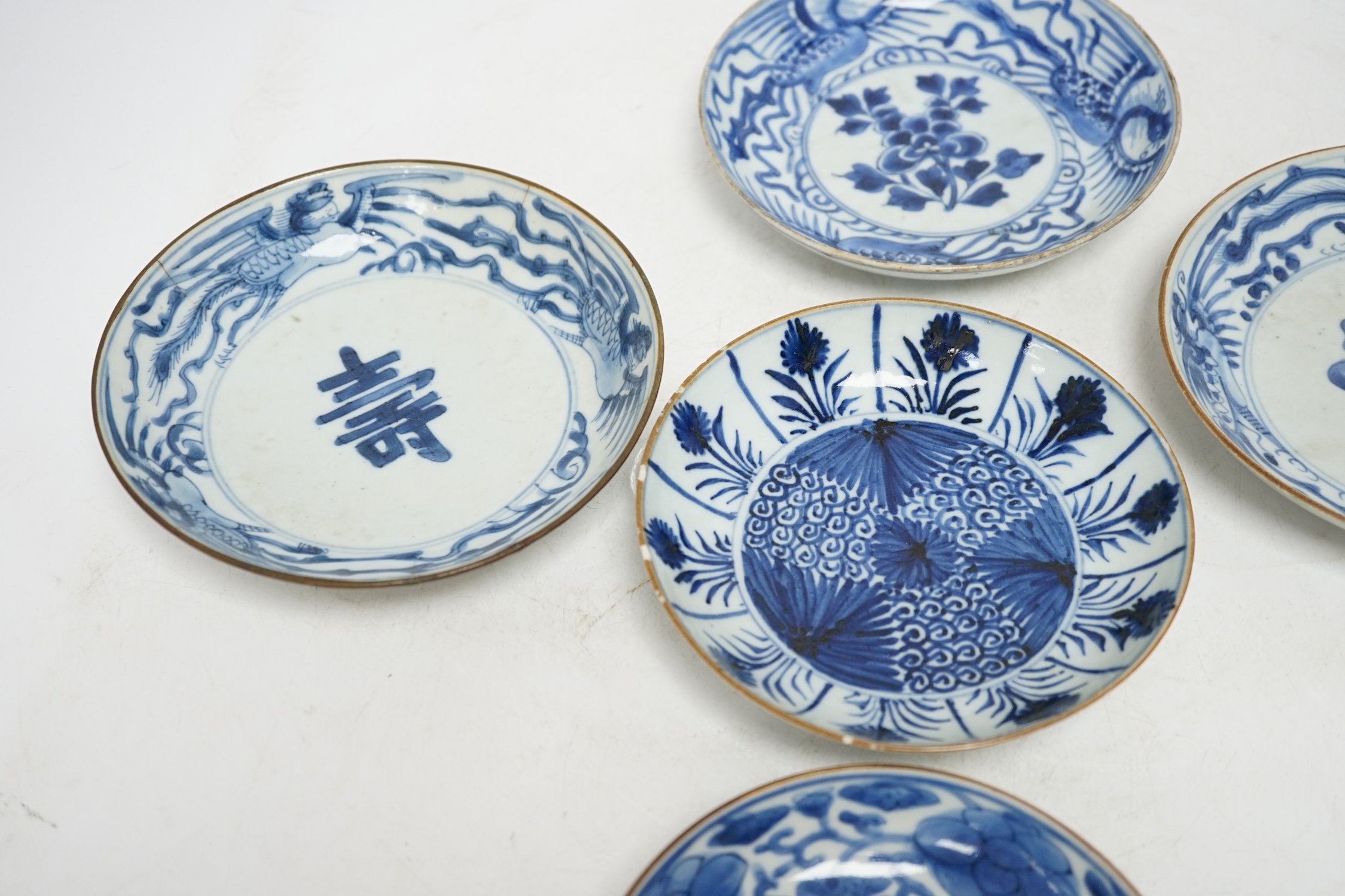 Five variously patterned Chinese blue and white saucer dishes, Kangxi period, largest 16cm diameter. Condition - chips and cracks to three items